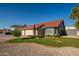 Attractive single-story home with a well-kept lawn, rock landscaping, and a red tile roof at 11615 N 77Th Dr, Peoria, AZ 85345