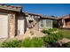 Inviting front entrance with manicured greenery and stone accents around the garage and entry at 11615 N 77Th Dr, Peoria, AZ 85345