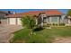 Charming home featuring a manicured lawn, mature tree, and a two-car garage at 11615 N 77Th Dr, Peoria, AZ 85345