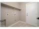 A functional laundry room has a shelf, tile floor, and hookups for a washer and dryer at 11615 N 77Th Dr, Peoria, AZ 85345