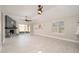 Bright living room featuring tile floors, a vaulted ceiling, and a modern fireplace at 11615 N 77Th Dr, Peoria, AZ 85345