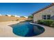Inviting backyard pool with a stone surround and well-maintained landscaping. View of the side yard at 11615 N 77Th Dr, Peoria, AZ 85345