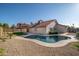 A refreshing pool with a shaped concrete border is surrounded by low-maintenance landscaping in this backyard at 11615 N 77Th Dr, Peoria, AZ 85345