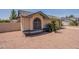 Single-story home featuring a gray tiled roof, neutral stucco, decorative window, and minimal desert landscaping at 1165 E Ivanhoe St, Chandler, AZ 85225