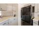 Spacious kitchen with black refrigerator, neutral countertops, and gray cabinetry at 1165 E Ivanhoe St, Chandler, AZ 85225