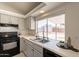 Updated kitchen featuring gray cabinets, a stainless steel sink, and a bright window at 1165 E Ivanhoe St, Chandler, AZ 85225