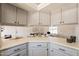 Bright kitchen with gray cabinetry and an open view to the living area at 1165 E Ivanhoe St, Chandler, AZ 85225