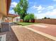 A sprawling backyard featuring a covered patio, lush grass, mature trees and hardscape at 1306 W 12Th St, Tempe, AZ 85281