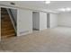 Finished basement featuring a staircase, neutral color palette, and multiple entrances to additional rooms at 1306 W 12Th St, Tempe, AZ 85281