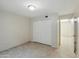 A bedroom with updated tile flooring, spacious closet, freshly painted walls and overhead lighting at 1306 W 12Th St, Tempe, AZ 85281