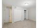 A bedroom with updated tile flooring, spacious closet, freshly painted walls and overhead lighting at 1306 W 12Th St, Tempe, AZ 85281