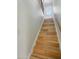 Bright staircase leading to an exit door, featuring hardwood steps and painted white risers at 1306 W 12Th St, Tempe, AZ 85281