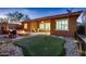 Beautiful backyard featuring a fire pit, outdoor seating, a putting green, and a tranquil atmosphere at 13145 W Whisper Rock Trl, Peoria, AZ 85383