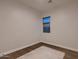 Empty bedroom with wood floors, neutral walls, and a large window offering plenty of natural light at 13145 W Whisper Rock Trl, Peoria, AZ 85383