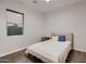Guest bedroom with a cozy bed, wood floors, contemporary design, and lots of natural light at 13145 W Whisper Rock Trl, Peoria, AZ 85383