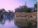 Picturesque community entrance with a stone waterfall, lush landscaping, and a welcoming sign at 13145 W Whisper Rock Trl, Peoria, AZ 85383