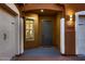 Inviting entryway featuring a gray front door, decorative lighting, and a charming window at 13145 W Whisper Rock Trl, Peoria, AZ 85383