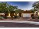 Charming single-story home featuring desert landscaping, warm exterior paint, and a two-car garage at 13145 W Whisper Rock Trl, Peoria, AZ 85383