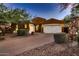 Stunning home featuring a brick driveway, well-manicured landscaping, and a spacious three-car garage at 13145 W Whisper Rock Trl, Peoria, AZ 85383
