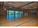Spacious gymnasium with hardwood floors, basketball hoops, and large windows, perfect for recreation at 13145 W Whisper Rock Trl, Peoria, AZ 85383