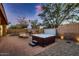 An inviting backyard featuring a luxurious hot tub, fire pit, and comfortable seating at 13145 W Whisper Rock Trl, Peoria, AZ 85383