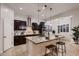 Modern kitchen with stainless steel appliances, a center island, and an adjacent dining area at 13145 W Whisper Rock Trl, Peoria, AZ 85383