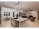 Open kitchen featuring a granite island, stainless steel appliances, and seamless flow to the living room at 13145 W Whisper Rock Trl, Peoria, AZ 85383