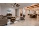Spacious living room and dining area with tile floors, beams, modern furnishings, and contemporary decor at 13145 W Whisper Rock Trl, Peoria, AZ 85383
