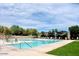 Relaxing community pool featuring many lounge chairs, shaded seating, and mountain views at 13145 W Whisper Rock Trl, Peoria, AZ 85383