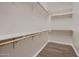 Functional walk-in closet with built-in shelving and wood floors, perfect for storage at 13145 W Whisper Rock Trl, Peoria, AZ 85383