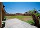 A backyard area, featuring a grassy lawn, string lights, perimeter wall, and privacy at 13601 W Hearn Rd, Surprise, AZ 85379