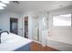 Bright bathroom with a separate shower, garden tub, and a door leading to a commode at 13601 W Hearn Rd, Surprise, AZ 85379