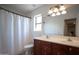 Bathroom featuring a double sink vanity with dark wood cabinetry and a tub and shower combo at 13601 W Hearn Rd, Surprise, AZ 85379