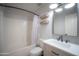 Clean bathroom featuring a shower and tub combination, modern vanity, and updated fixtures at 13601 W Hearn Rd, Surprise, AZ 85379
