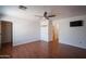 Bedroom featuring wood-look floors, a ceiling fan, and access to an adjacent laundry room at 13601 W Hearn Rd, Surprise, AZ 85379
