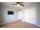 A bedroom with neutral paint, a ceiling fan, a wall mounted television, and closet with sliding doors at 13601 W Hearn Rd, Surprise, AZ 85379