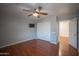 Bedroom featuring wood-look floors, ceiling fan, mounted television, and a closet with sliding doors at 13601 W Hearn Rd, Surprise, AZ 85379