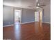 Spacious bedroom featuring hardwood floors, neutral gray walls, and ensuite bathroom at 13601 W Hearn Rd, Surprise, AZ 85379