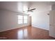 Bedroom with a ceiling fan, wood-look flooring, and lots of natural light from the windows at 13601 W Hearn Rd, Surprise, AZ 85379