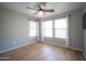 Light-filled bedroom with neutral paint, a ceiling fan, and three windows for ample natural light at 13601 W Hearn Rd, Surprise, AZ 85379