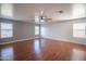 Bright and airy bedroom featuring hardwood floors, neutral gray walls, and ample natural light at 13601 W Hearn Rd, Surprise, AZ 85379