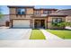 Inviting two-story home featuring a tile roof, manicured lawn, and a welcoming front porch at 13601 W Hearn Rd, Surprise, AZ 85379