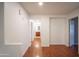 Upstairs hallway leading to bedrooms and bathrooms, showcasing the home's bright, neutral design scheme at 13601 W Hearn Rd, Surprise, AZ 85379