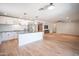 Open floor plan featuring a kitchen with white cabinetry, stainless appliances, and spacious adjacent living area at 13601 W Hearn Rd, Surprise, AZ 85379