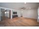Open-concept living room offering wood-look floors, recessed lighting, and a media console at 13601 W Hearn Rd, Surprise, AZ 85379