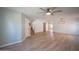 Spacious living room boasting modern light fixture, a ceiling fan, and wood-look flooring at 13601 W Hearn Rd, Surprise, AZ 85379