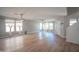 Bright, airy living room with wood-look flooring, a modern light fixture, and ample natural light at 13601 W Hearn Rd, Surprise, AZ 85379