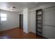 Spacious walk-in closet with wood look floors, lots of shelving and hanging storage at 13601 W Hearn Rd, Surprise, AZ 85379