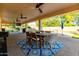 The back patio has ceiling fans, a TV and overlooks the pool at 14687 W Amelia Ave, Goodyear, AZ 85395