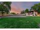 Large backyard with sand volleyball court and outdoor kitchen area at 14687 W Amelia Ave, Goodyear, AZ 85395